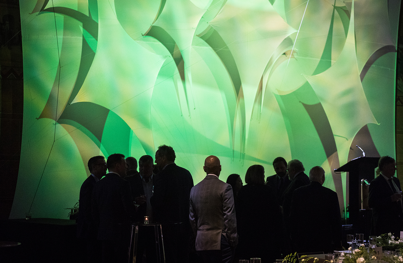 Attendees mingle in front of custom large-scale graphics