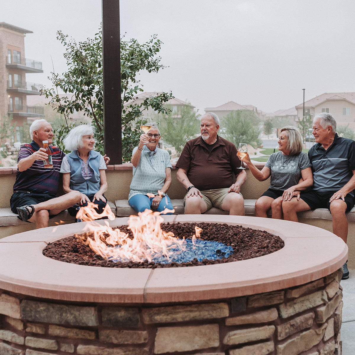 Seniors sitting around a fire pit.